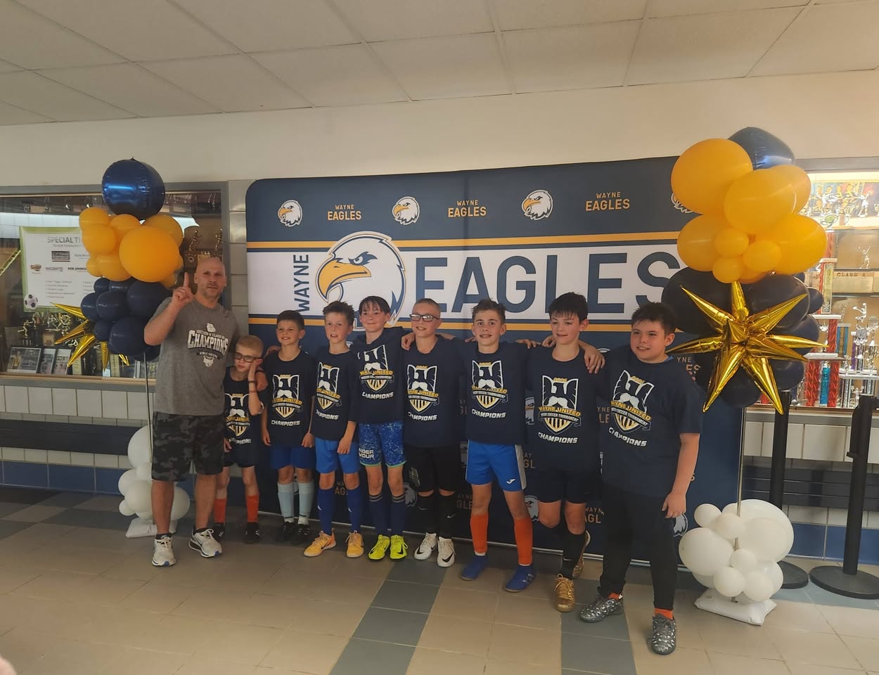 Team lined up together in Wayne United champions shirts