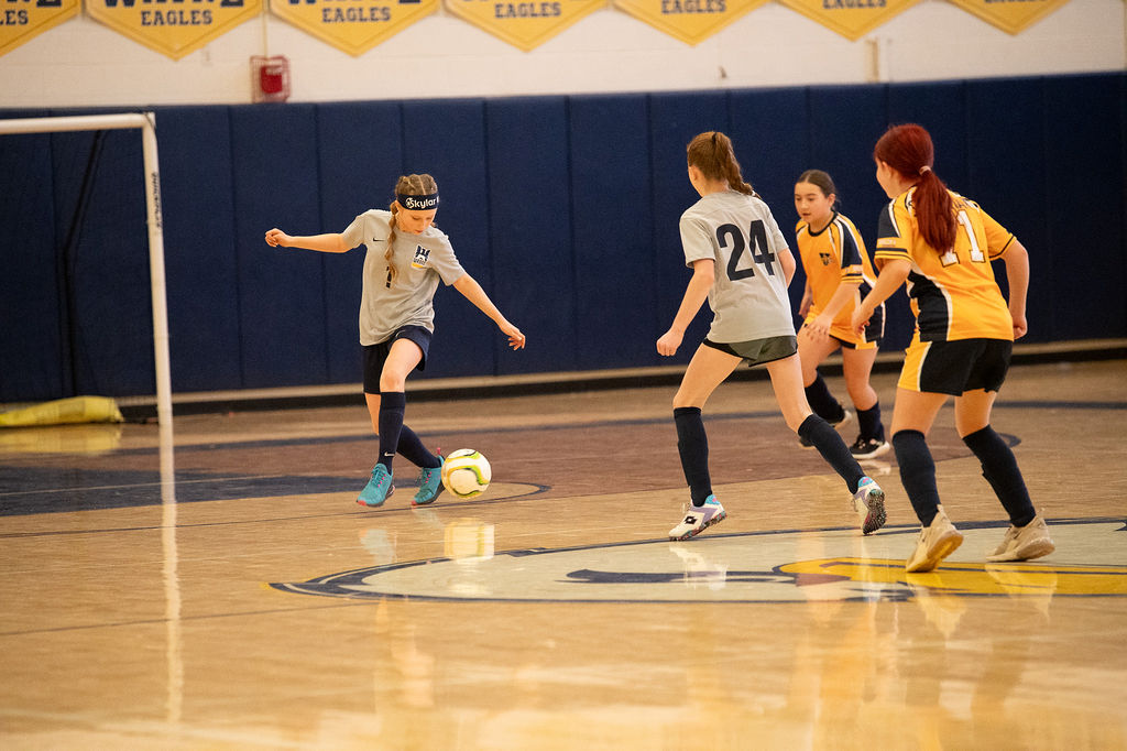 Wayne United player driving forward with the ball