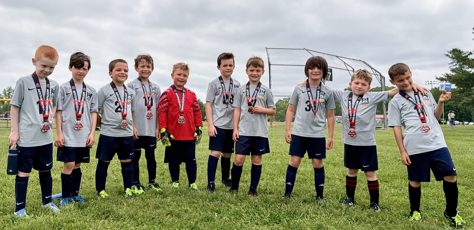 Wayne United players celebrating with medals